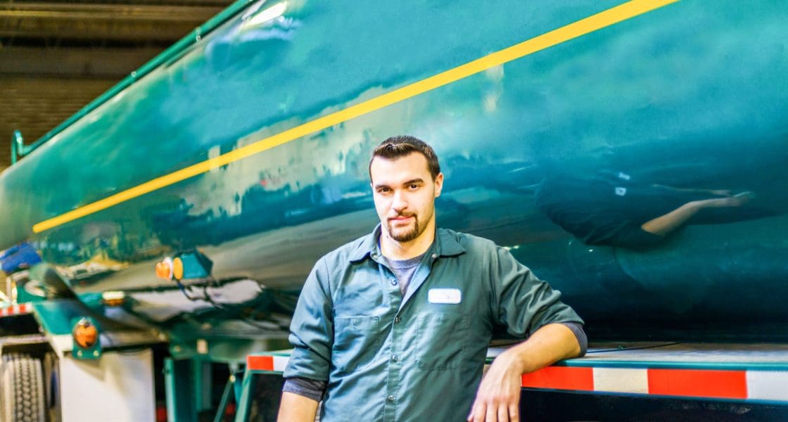 Portrait of young male trucker at biofuel industrial plant